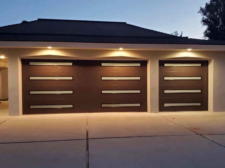 Modern dark garage door on a Sacramento home at dusk